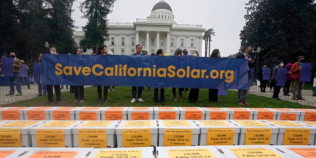 Boxes of petitions against proposed reforms that solar energy advocates claim would handicap the rooftop solar market are displayed before they are taken to the governor's office during a rally at the Capitol in Sacramento, California, Wednesday, Dec. 8, 2021.