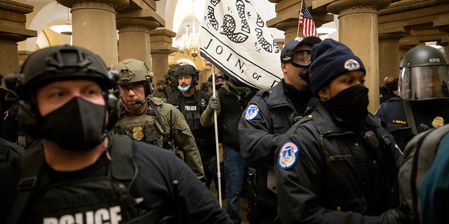FBI and ATF law enforcement push supporters of President Trump out while protesting inside the US capital on January 6, 2021 in Washington, DC  