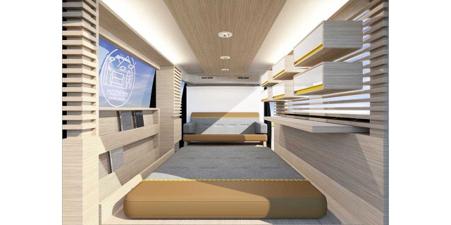 The Nissan Myroom is equipped with a bed, sofa, shelves and drawers.