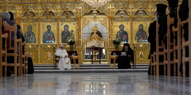 Pope Francis, left, listens to Archbishop Chrisostomos during a ceremony at the Apostolos Barnavas Orthodox Cathedral in Nicosia, Cyprus, Friday, Dec. 3, 2021. 