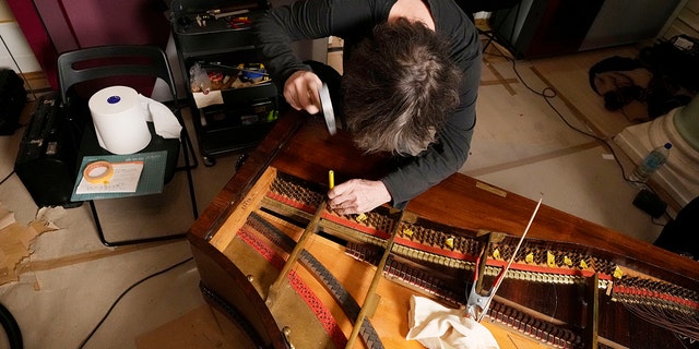 Texas-born expert on historic pianos, Paul McNulty, renovates the last piano that Frederic Chopin played and composed on, at the Chopin museum in Warsaw, Poland, on Thursday, Dec. 9, 2021. 