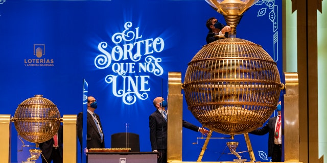 Workers prepare numbered lottery balls at Madrid's Teatro Real opera house during Spain's bumper Christmas lottery draw known as El Gordo, or The Fat One, in Madrid, Spain, Wednesday, Dec. 22, 2021.