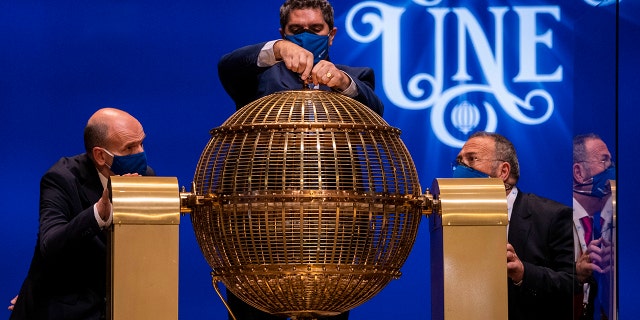 Workers prepare prize lottery balls at Madrid's Teatro Real opera house during Spain's bumper Christmas lottery draw known as El Gordo, or The Fat One, in Madrid, Spain, Wednesday, Dec. 22, 2021.