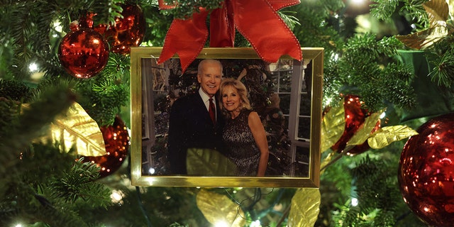 An ornament with a portrait of President Joe Biden and first lady Jill Biden is hung on a Christmas Tree in the State Dining Room of the White House Nov. 29, 2021.