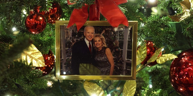An ornament with a portrait of President Joe Biden and first lady Jill Biden is hung on a Christmas Tree in the State Dining Room of the White House Nov. 29, 2021.