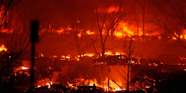 A wildfire destroyed homes near Rock Creek Village. (AP Photo/David Zalubowski)