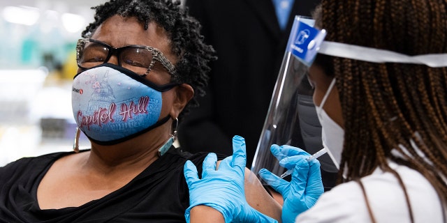 Germaine T. Leftwich, 67, receives a Pfizer covid-19 vaccine booster shot from Dr. Tiffany Taliaferro at the Safeway on Capitol Hill in Washington, D.C., on Monday, October 4, 2021.