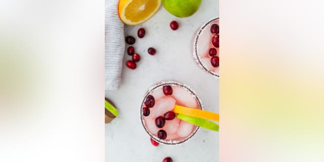 This holiday margarita includes fresh cranberries and orange or lime wedges for garnish.