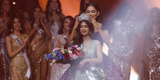 Miss Universe 2020 Andrea Meza, right, crowns India's Harnaaz Sandhu as Miss Universe 2021 during the 70th Miss Universe pageant, Monday, Dec. 13, 2021, in Eilat, Israel. 