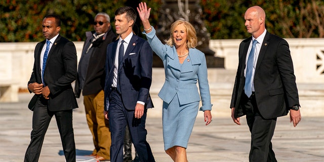 Mississippi Attorney General Lynn Fitch, center right, accompanied by Mississippi Solicitor General Scott Stewart, center left, waves to supporters as they walk out of the U.S. Supreme Court Wednesday.