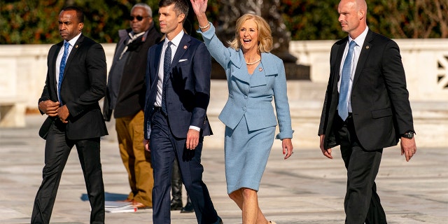 Mississippi Attorney General Lynn Fitch, center right, accompanied by Mississippi Solicitor General Scott Stewart, center left, waves to supporters as they walk out of the U.S. Supreme Court Wednesday.