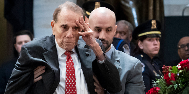 WASHINGTON, DC - DECEMBER 4: Former Senator Bob Dole stands up and salutes the casket of the late former President George H.W. Bush as he lies in state at the U.S. Capitol, December 4, 2018 in Washington, DC. (Photo by Drew Angerer/Getty Images)