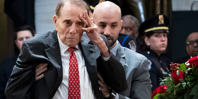 WASHINGTON, DC - DECEMBER 4: Former Senator Bob Dole stands up and salutes the casket of the late former President George H.W. Bush as he lies in state at the U.S. Capitol, December 4, 2018 in Washington, DC. (Photo by Drew Angerer/Getty Images)