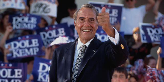 Senator Bob Dole gives the "thumbs up" sign during a presidential rally. Senator Dole won the Republican nomination for president in 1996, but lost the election to Bill Clinton. 
