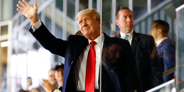 Former President Donald Trump is waving before Game 4 of the World Series in Atlanta on October 30, 2021.