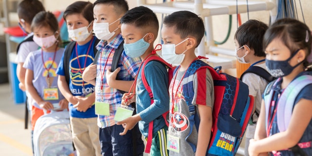 Masked students wait to go to their classroom during the first day of class at Stanford Elementary School in Garden Grove, CA on Monday, August 16, 2021. (Photo by Paul Bersebach/MediaNews Group/Orange County Register via Getty Images)