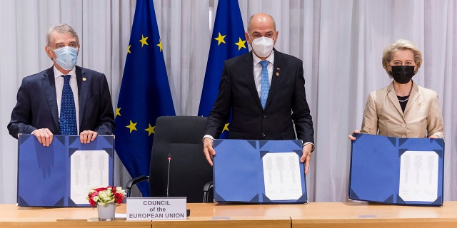 From left, European Parliament President David Sassoli, Slovenia's Prime Minister Janez Jansa and European Commission President Ursula von der Leyen during a signing ceremony of EU Legislative Priorities for 2022 on the sidelines of an EU Summit in Brussels, Thursday, Dec. 16, 2021.