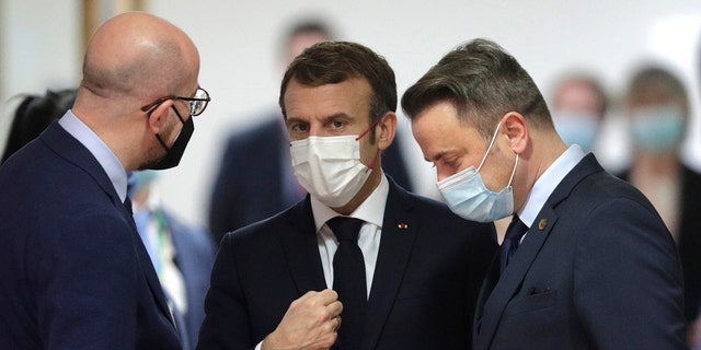 French President Emmanuel Macron, center, speaks with European Council President Charles Michel, left, and Luxembourg's Prime Minister Xavier Bettel, right, during a round table meeting at an EU Summit in Brussels, Thursday, Dec. 16, 2021. 