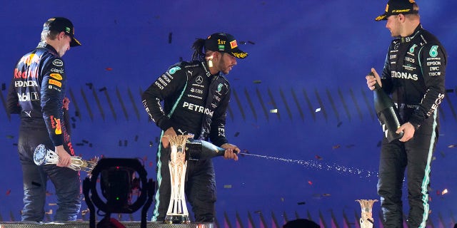 Hamilton (center) finished ahead of Verstappen (left) and Valtteri Botas (right).