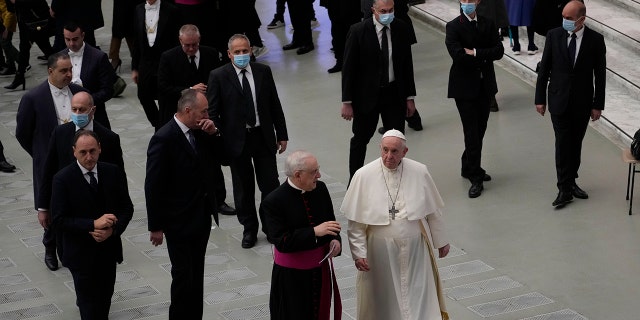 Pope Francis walks towards faithful at the end of his weekly general audience in the Paul VI Hall, at the Vatican, Wednesday, Dec. 22, 2021.