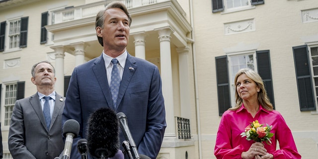 Glenn Youngkin, governor-elect of Virginia, center, speaks to members of the media as Ralph Northam, governor of Virginia, left, and Suzanne Youngkin listen outside the Executive Mansion in Richmond, Virginia, on Thursday, Nov. 4, 2021.