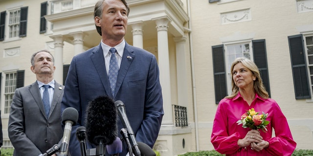 Glenn Youngkin, governor-elect of Virginia, center, speaks to members of the media as Ralph Northam, governor of Virginia, left, and Suzanne Youngkin listen outside the Executive Mansion in Richmond, Virginia, on Thursday, Nov. 4, 2021.