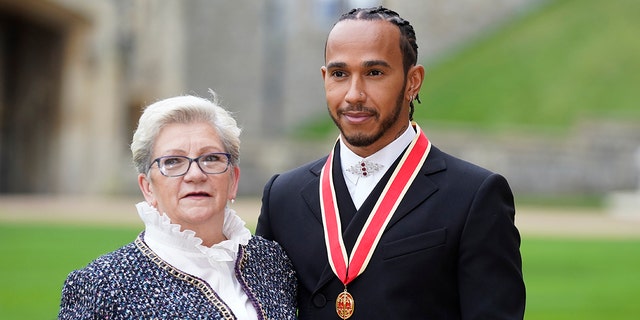 Lewis Hamilton was accompanied to the ceremony at Windsor Castle by his mother Carmen Lockhart.
