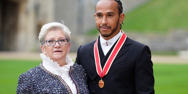 Lewis Hamilton was accompanied to the ceremony at Windsor Castle by his mother Carmen Lockhart.