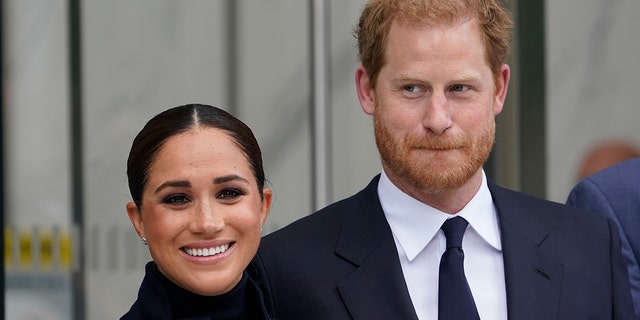 Meghan Markle and Prince Harry pose for pictures after visiting the observatory in One World Trade in New York, Thursday, Sept. 23, 2021. 