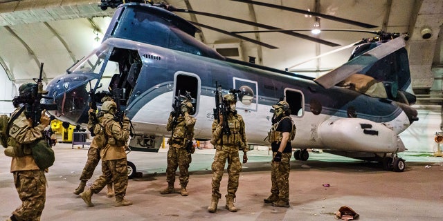 AUGUST 31, 2021: Taliban fighters wielding American supplied weapons, equipment and uniforms, at the Kabul International Airport. (MARCUS YAM / LOS ANGELES TIMES)