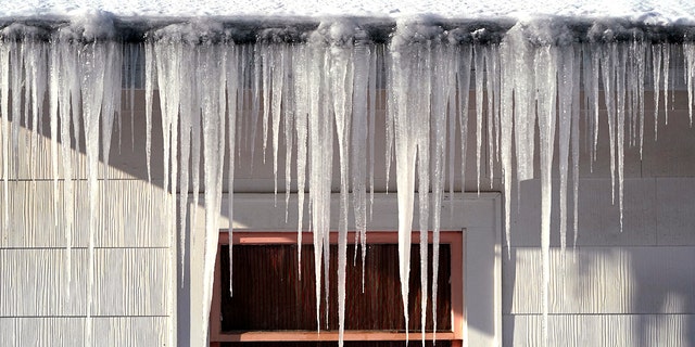 Long icicles hang from a house where nearly a foot of snow fell over the weekend, Monday, Dec. 27, 2021, in Bellingham, Washington. 