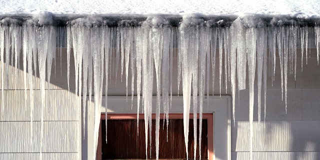 Long icicles hang from a house where nearly a foot of snow fell over the weekend, Monday, Dec. 27, 2021, in Bellingham, Washington. 