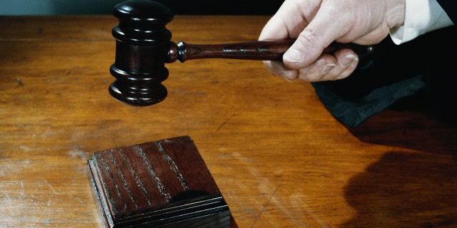 Close up of judge holding gavel