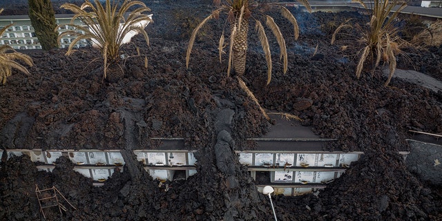 Lava covers the cemetery of La Manchas on the Canary Island of La Palma, Spain, on Wednesday, December 1, 2021. 