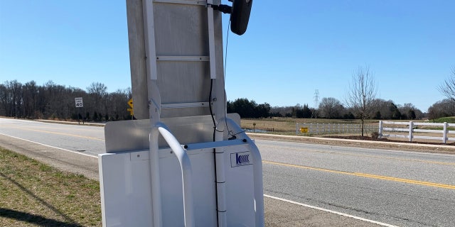 A license plate reader scanning passing cars.