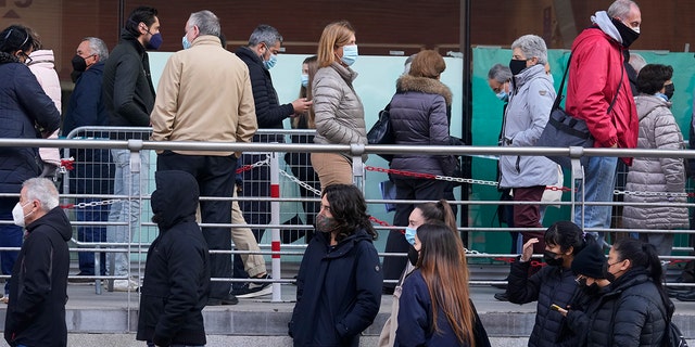 People queue for Pfizer COVID-19 vaccinations in the Wizink Center in Madrid, Spain, Wednesday, Dec. 1, 2021. Health authorities in the Spanish capital have confirmed a second case of the omicron coronavirus variant in a 61-year-old woman who had returned from a trip to South Africa on Monday. 