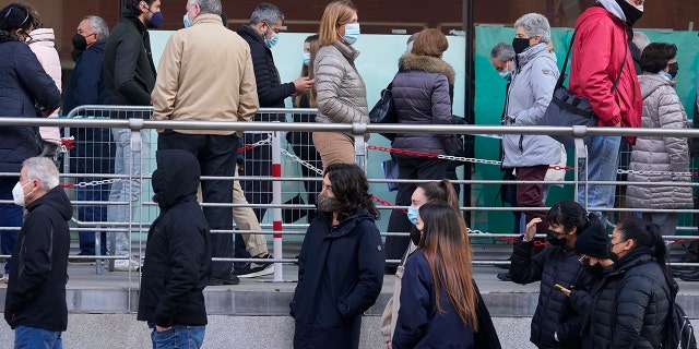 People queue for Pfizer COVID-19 vaccinations in the Wizink Center in Madrid, Spain, Wednesday, Dec. 1, 2021. Health authorities in the Spanish capital have confirmed a second case of the omicron coronavirus variant in a 61-year-old woman who had returned from a trip to South Africa on Monday. 