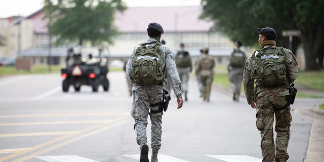 Service members walk at Maxwell Air Force Base.