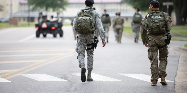 Service members walk at Maxwell Air Force Base.