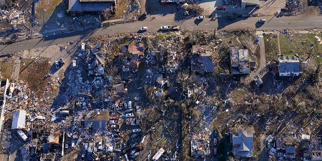 In this aerial photo, destruction from a recent tornado is seen in downtown Mayfield, Ky., located about 70 miles from Dawson Springs, on Sunday, Dec. 12, 2021. (AP Photo/Gerald Herbert)