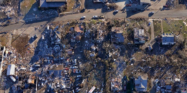 In this aerial photo, destruction from a recent tornado is seen in downtown Mayfield, Ky., located about 70 miles from Dawson Springs, on Sunday, Dec. 12, 2021. (AP Photo/Gerald Herbert)