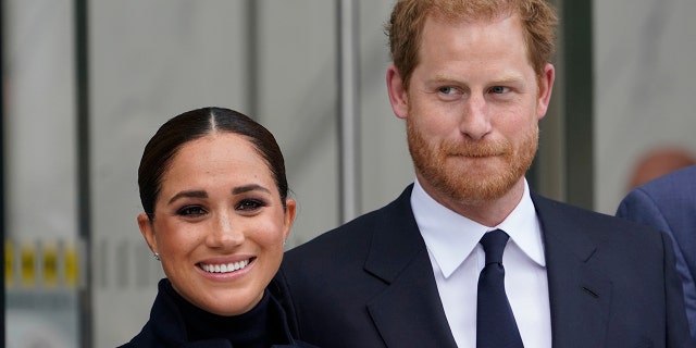 Meghan Markle and Prince Harry pose for pictures after visiting the observatory in One World Trade in New York on Sept. 23, 2021.