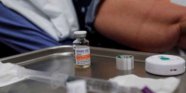 FILE PHOTO: A vial of Regeneron monoclonal antibody sits on a medical table as registered nurse Jessica Krumwiede attempts to find a vein to administer it to Cathy Hardin, who was vaccinated prior to testing positive for the coronavirus disease (COVID-19), at the Sarasota Memorial Urgent Care Center in Sarasota, Florida, U.S., September 23, 2021. REUTERS/Shannon Stapleton