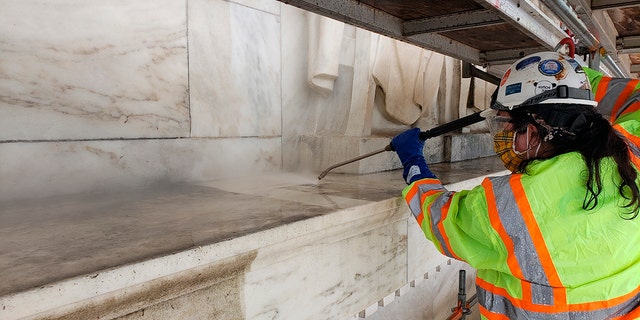 Architectural conservators apply steam to the Jefferson Memorial as part of the GAOA-funded cleaning of the memorial in Washington. 