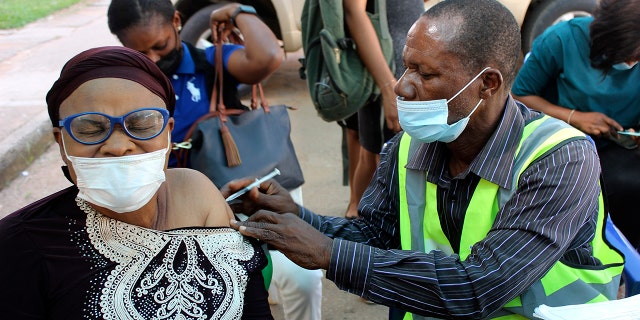 A woman receives a coronavirus vaccine in Abuja, Nigeria, Monday, Nov 29, 2021.