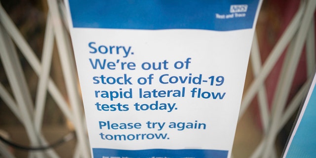 A sign saying lateral flow coronavirus tests are out of stock is displayed in a pharmacy window in London, Thursday Dec. 30, 2021.