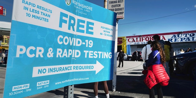 People line up for a free COVID-19 speed test at a gas station in the Reseda section of Los Angeles on Sunday, December 26, 2021, while California prepares for a virus rise after the holidays. 