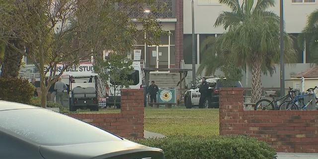 Police wait outside Florida Tech dorms as the investigation into an incident involving a knife-wielding student continues. 