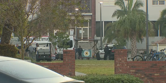 Police wait outside Florida Tech dorms as the investigation into an incident involving a knife-wielding student continues.
