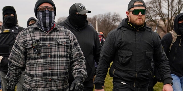 Proud Boys members Joseph Biggs, left, and Ethan Nordean, right with megaphone, walk toward the U.S. Capitol in Washington, Jan. 6, 2021.